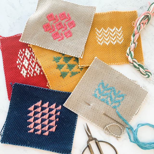 1. Four colored squares featuring distinct designs: one striped, one polka-dotted, one solid, and one checkered.