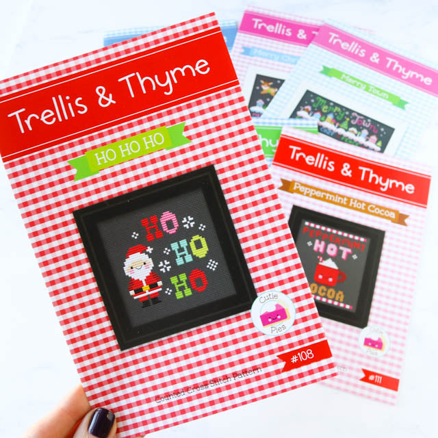 Cross stitch kit featuring trolls and thyme design for Christmas crafting.
