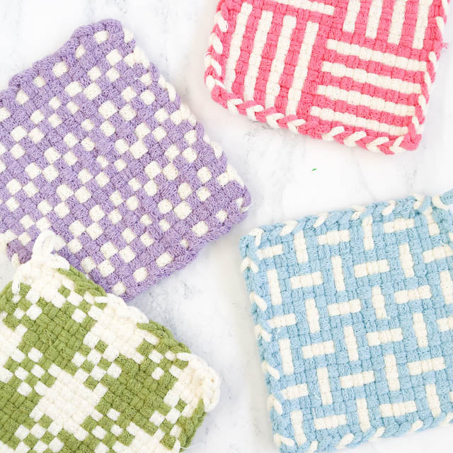 1. Four colorful coasters featuring unique designs, arranged in a square layout on a neutral background.
