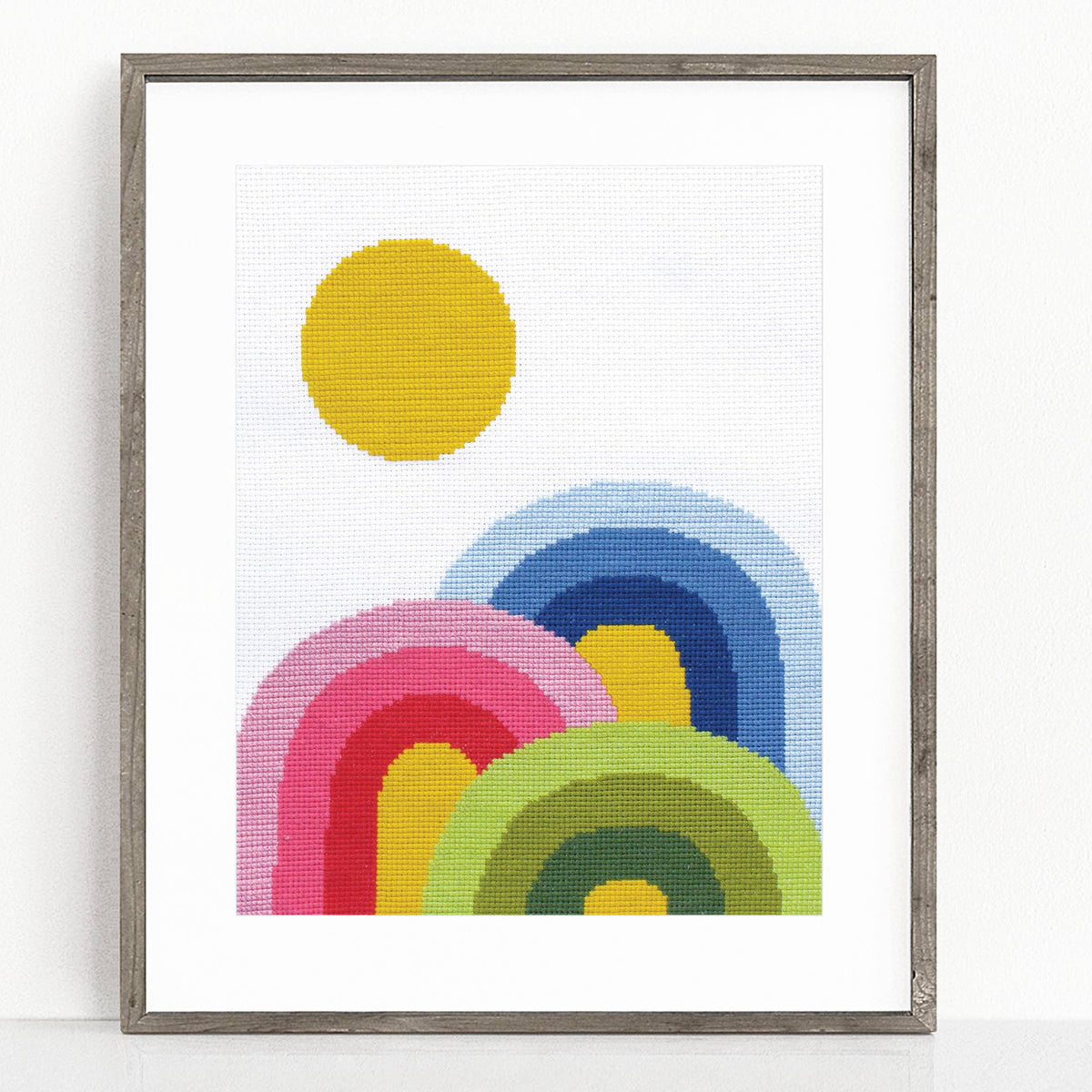 Framed artwork with colorful circular design on a white background