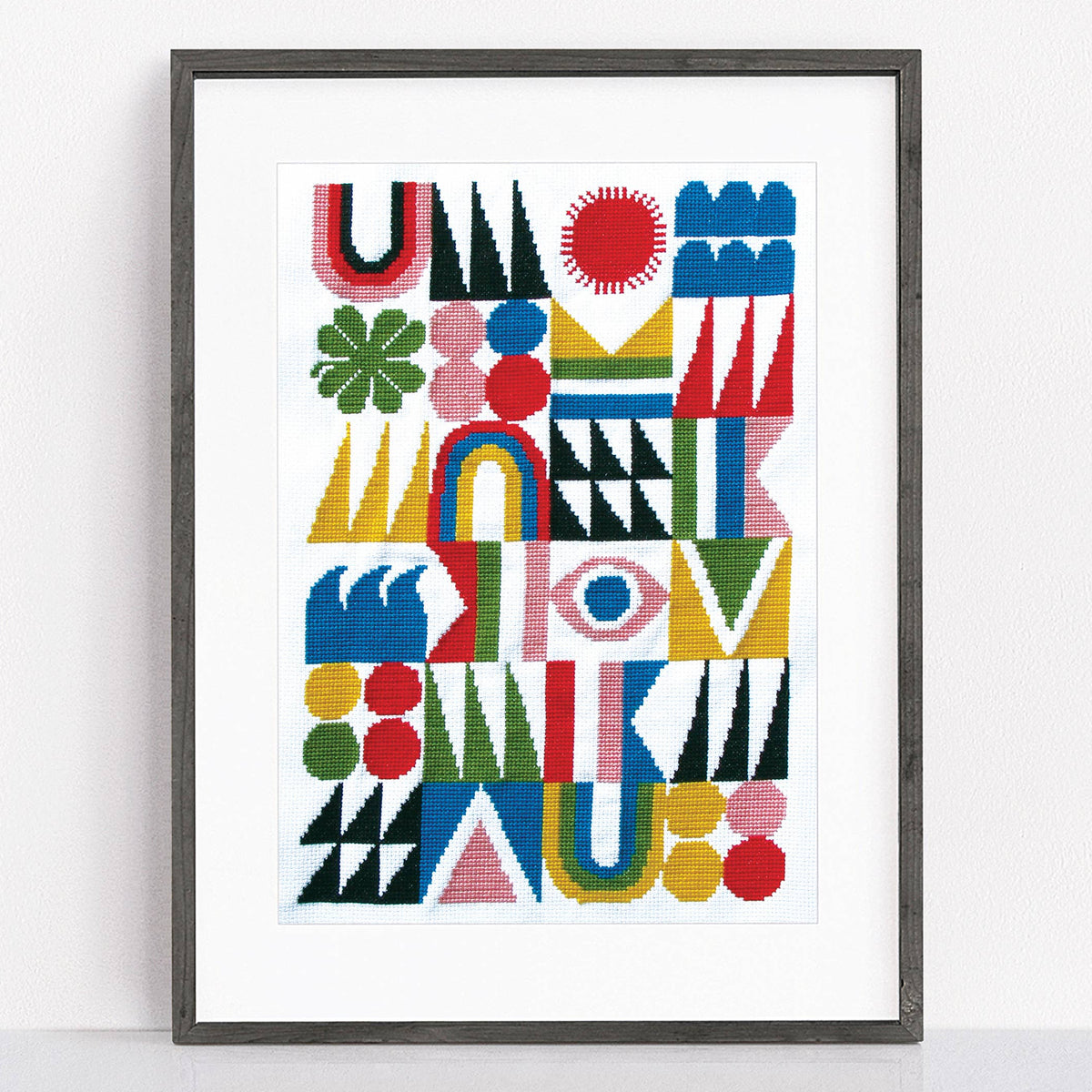 Framed abstract artwork with colorful geometric shapes on a white background