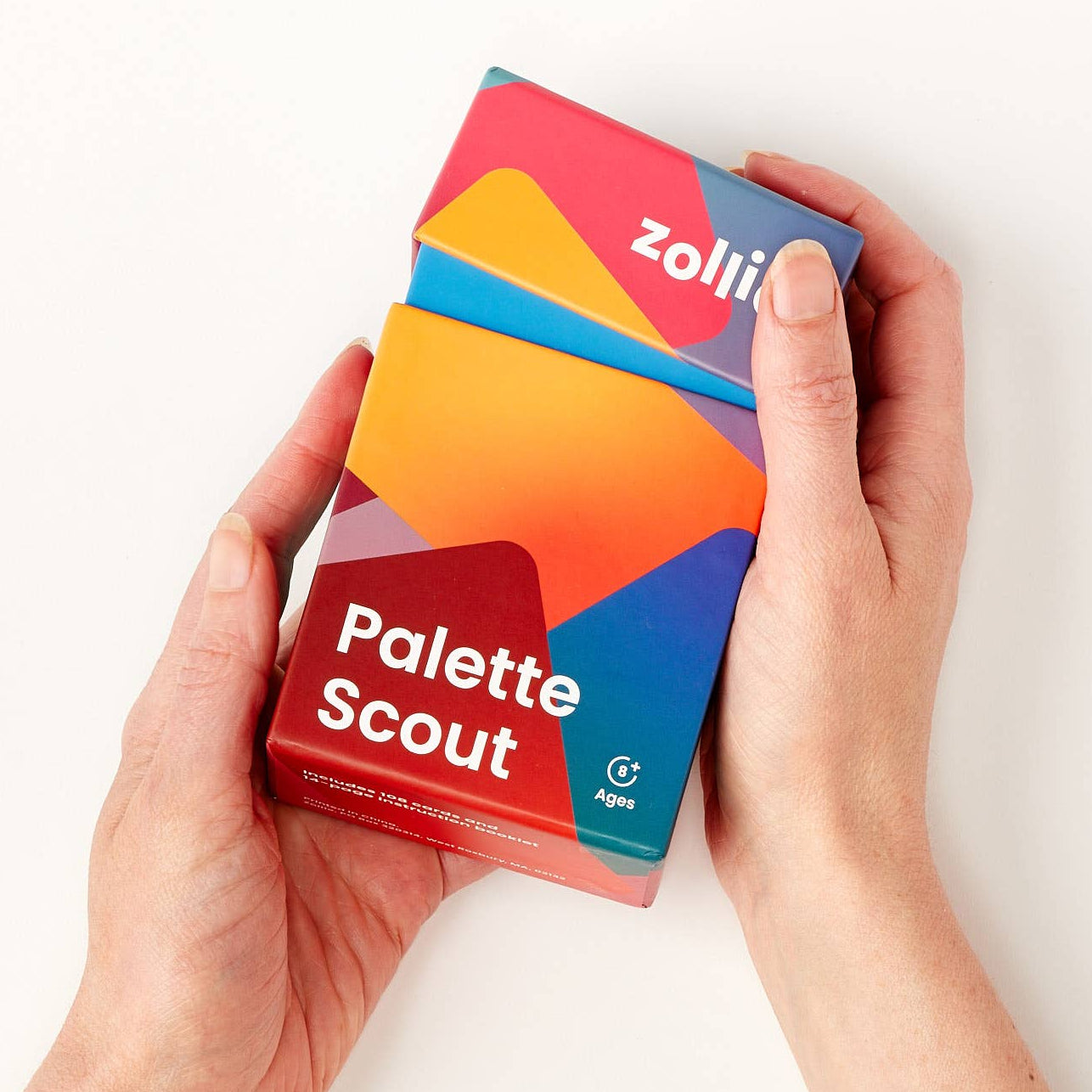 Colorful 'Palette Scout' packaging held by hands on a white background